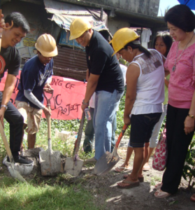 Kalahi-CIDSS National Project Manager Edgar G. Pato (center) leads the groundbreaking ceremony as Herminia Lorenzo (extreme right) of Zonta Club of Cavite looks on