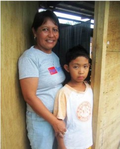 Normelita Rivera with her youngest son, Jan Ryan in front of Unit 57, their temporary home.