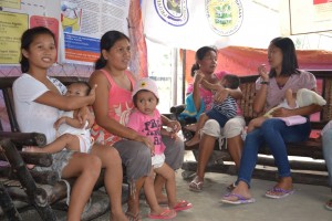Nursing mothers gather and chat inside a women-friendly space in New Bataan, Compostela Valley Province. A women-friendly space is a designated tent inside an evacuation center or a relocation site that provides internally-displaced women with a safe place to meet, talk and help each other.