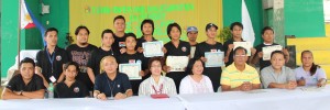 Graduates of the arch metal welding training proudly show off their certificates of completion. They are accompanied by DSWD staff, Barangay Captain Ronald Victor, and Kalahi-CIDSS volunteers.