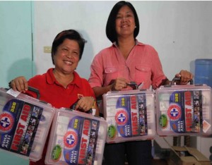 DSWD Secretary Dinky Soliman beams as she receives the first aid kit donation of the MVP Group of Companies from Ms. Mechie Sivestre, Executive Director of Alagang Kapatid Foundation.