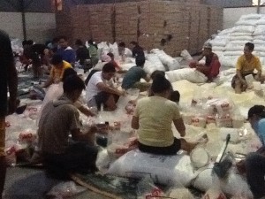 Volunteers repack relief goods at the DSWD warehouse in Pasay City.