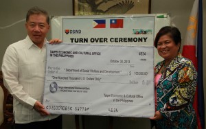  Secretary Soliman and Ambassador  Wang beam as they present the check donation.