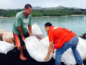 A member of the DSWD Team helps unload a sack of relief goods for the earthquake victims in Loon, Bohol.