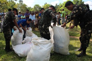 Soldiers help pack relief goods for distribution to Carmen, Bohol.