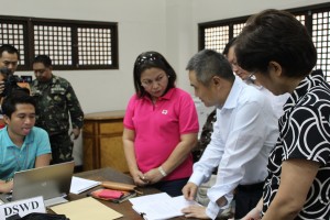 DSWD-VII Regional Director Mercedita Jabagat talks to  People’s Republic of China Economic & Commercial Counsellor Wu Zhengping at the One Stop Station for international donations  in Mactan Airbase, Lapu-Lapu City.