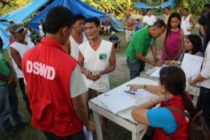 CFW beneficiaries in Loon, Bohol receive their pay in exchange for helping set-up tents as temporary shelters for families outside evacuation centers.