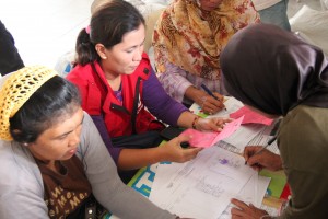 Jamila Arasid attends to the questions of some residents