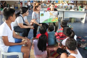 Children listen intently to the storytellers during a storytelling session in an evacuation center in Cebu City.