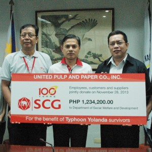 DSWD Assistant Secretary Javier Jimenez receives the check donation of United Pulp and Paper Co., Inc. Volunteers are still enthusiastic to lend a helping hand