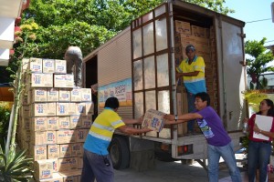 Volunteers unloading the goods from Department of Agriculture.