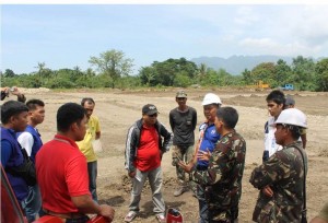 Engineers of DSWD, IOM and  52nd Engineering Brigade discuss details and plans for the bunkhouses during their ocular inspection at the site.  