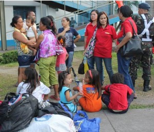 'Yolanda' survivors wait for the ride that will take them to their relatives places.