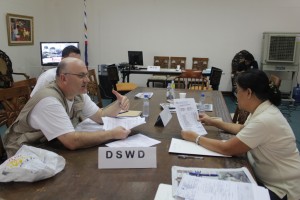 A DSWD social worker processes the donation of the International Medical Corps at the One-Stop- Station at Mactan Airbase.