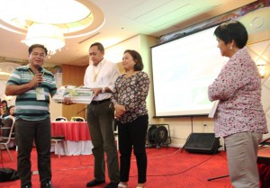 Kalahi-CIDSS Deputy National Program Manager Tomi Cabuenos and DSWD FO7 Regional Director Mercedita Jabagat turn over the TEMS field guide to LGUs, as represented by Mayor Joselito Miquiabas of Bacolod, Lanao del Norte