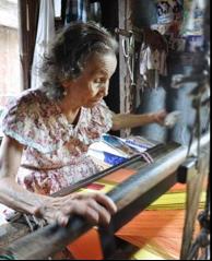 Lola Perpetua weaving a table runner