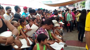 PREPARATIONS. Families line up to get their documents processed at the Relocation Action Center, right before they travel in vans to Cavite.