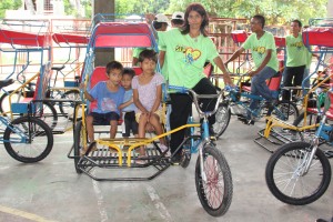 Helen and kids try the brand new trisikad her family received from DSWD.