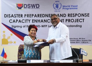 DSWD Secretary Corazon Juliano-Soliman and World Food Program Country Director Praveen Agrawal exchange documents during the Signing Ceremony for the Letter of Understanding between the DSWD and the UN-WFP on Disaster Preparedness and Response Capacity Enhancement Project.