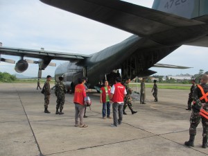 DSWD-Field Office 7 staff wait for the unloading of relief goods from the C-130