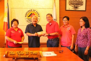 Gov. Tanco (2nd from left) and Panay Mayor Dante Bermejo (third  from left) together with DSWD and LGU staff during the turn over of check.