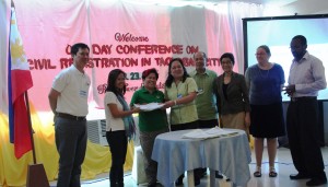 DSWD Secretary Dinky Soliman together with representatives from the Philippine Statistics Authority and Civil Society Organizations in a ceremonial turn-over activity where 2,110 Yolanda survivors benefit from the mobile birth registration project.