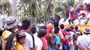 Evacuees in Maguindanao wait for their turn to receive their DSWD food packs from volunteers.