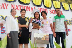 Arlyn beams after receiving her awards as top achiever of her class at Sagay National High School.