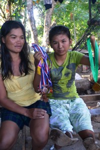 Edy Rose shows her medals, the proof of her academic excellence.