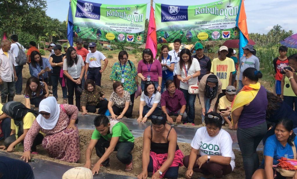 Participants of the DSWD-SM Foundation skills training on organic farming apply the farming techniques they have learned.