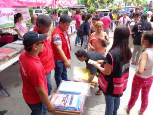 Staff from DSWD Field Office - National Capital Region and Disaster Response Management Bureau distribute relief aid in the form of food and non-food items to the victims of the recent Malabon fire.