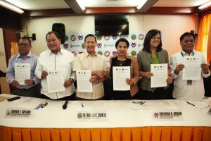 Department of Social Welfare and Development (DSWD) Secretary Virginia N. Orogo (third from right) and Department of Health (DOH) Secretary Francisco Duque III (third from left) present the newly-signed Joint Administrative Order on Streamlining Access to Medical Assistance Fund of the Government. Also in photo are (from left to right): Jose R. Reyes Memorial Medical Center Chief Dr. Emmanuel F. Montaña, Jr., Presidential Assistant for Special Concerns Wendel Avisado, PhilHealth Vice President for Corporate Affairs Group Dr. Shirley Domingo, and PCSO OIC Assistant General Manager Rubin Magno.