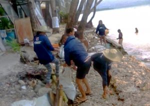 Displaced informal workers from Boracay Island engage in coastal clean-up activities as part of their labor for the Cash-for-Work (CFW) program. 