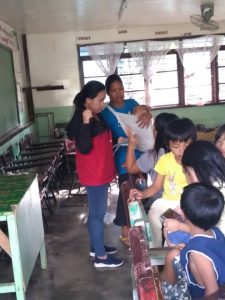 A social worker from DSWD-FO CAR attends to the needs of lactating mothers and children at an evacuation center in Itogon, Benguet.
