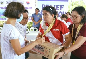 Department of Social Welfare and Development (DSWD) Secretary Virginia N. Orogo (center) leads the distribution of family food packs in Nueva Ecija. Also with her is DSWD Field Office (FO) III Regional Director Gemma Gabuya (right).