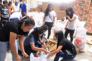Students repack family food packs