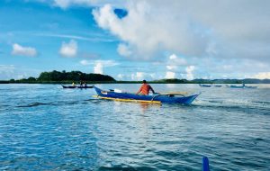 A Dumagat fisherman starts fishing using the fiberglass boat provided by the DSWD.