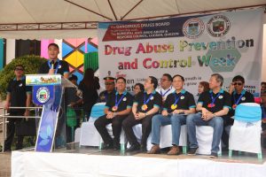 Department of Social Welfare and Development (DSWD) Assistant Secretary Jose Antonio Hernandez (far left) highlights the Yakap Bayan program during his speech at the Drug Abuse Prevention and Control (DAPC) week kick off celebration in Lucban, Quezon. Also present in the activity are (from L-R) Dangerous Drugs Board (DDB) Usec. Earl Saavedra, Lucban Mayor Celso Olivier Dator, DDB Sec. Catalino Cuy, and DDB Usec. Benjamin Reyes.