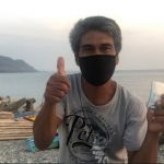 Even with his face mask on, Dominador is visibly happy as he gestures a thumbs up after receiving his emergency subsidy under the Social Amelioration Program.