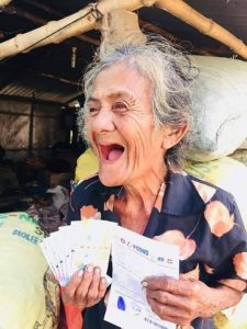 Florentina A. Alagao, a 72-year-old resident of Barangay Malpeg-Patalan, Cuyapo in Nueva Ecija, beams after receiving her emergency cash subsidy under the Social Amelioration Program.