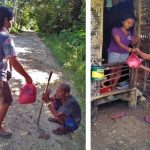Robilon Coralde, a beneficiary of the Modified Conditional Cash Transfer (MCCT) Program under the Pantawid Pamilyang Pilipino Program (4Ps) of the Department of Social Welfare and Development (DSWD), distributes the goods she bought using her Social Amelioration Program (SAP) cash subsidy to families in need in her community.