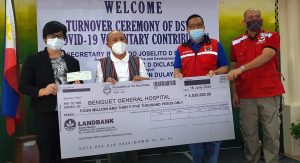 Department of Social Welfare and Development (DSWD) Undersecretary for General Administration and Support Services Group Jose Ernesto B. Gaviola (2nd from right) and Field Office Cordillera Administrative Region Director Leo Quintilla (right) hand over to Benguet Province Governor Dr. Melchor D. Diclas (2nd from left) and Benguet General Hospital Chief Dr. Meliarazon Dulay (left) the check for the P4 million DSWD donation to the hospital.