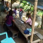 Christine Pia Oviedo, (in pink blouse), one of the young professionals tapped by Barangay Sta. Rita in Olongapo City, interviews a family during the assessment of beneficiaries of the Social Amelioration Program (SAP) in the community