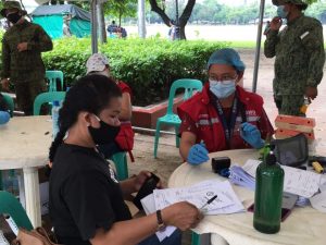 A social worker of the Department of Social Welfare and Development (DSWD) facilitates the payout of financial aid to a locally stranded individual during the Hatid Tulong Grand Send Off at Quirino Grandstand.