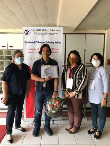 Department of Social Welfare and Development (DSWD) staff, Daniel Tolentino, receives his Certificate of Appreciation as a Ruby Awardee for donating blood over the years to the National Kidney and Transplant Institute (NKTI).  Joining him during the simple awarding ceremony on October 1 are (from left to right) NKTI Blood Recruitment Team Coordinator Shiela Villamor; DSWD Medical Officer, Dr. Madeline Alcusin; and DSWD Resident Nurse Nora Eustaquio.