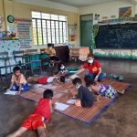 A social worker of the Department of Social Welfare and Development (DSWD) facilitates the psychosocial processing of children evacuees in Guinobatan East Central School, Albay.