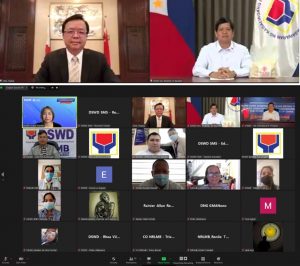 Department of Social Welfare and Development Secretary ROlando Joselito D. Bautista (right) and Chinese Ambassador Hung Xilian during the online handover ceremony of the donated rice.