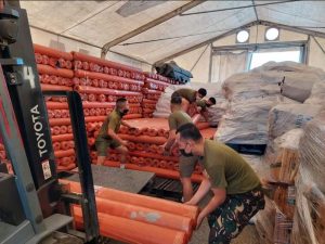 Military personnel haul 500 laminated sacks for delivery to Butuan-Surigao. The rolls of laminated sacks sized 8 ft x 100 meters when cut into 10 meters could benefit about 5,000 individuals and/ or families affected by Typhoon Odette in CARAGA Region.