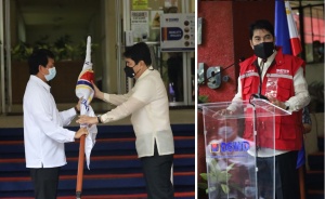 Outgoing Secretary Rolando Joselito D. Bautista turns over the flag of the Department of Social Welfare and Development (DSWD) to incoming Secretary Erwin T. Tulfo symbolizing the handover of the Department's leadership. Right photo shows DSWD Secretary Erwin T. Tulfo wearing the DSWD red vest as he gives his first address to the employees.