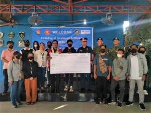 Undersecretary for Inclusive and Sustainable Peace Alan A. Tanjusay (in red vest) attends the awarding ceremony of livelihood settlement grants to 17 former rebels on Tuesday, December 20, in Taguig City.